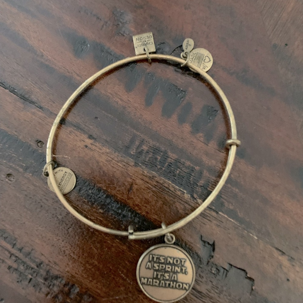 Alex and Ani bracelet with Its not a sprint  it’s a marathon charm attached.